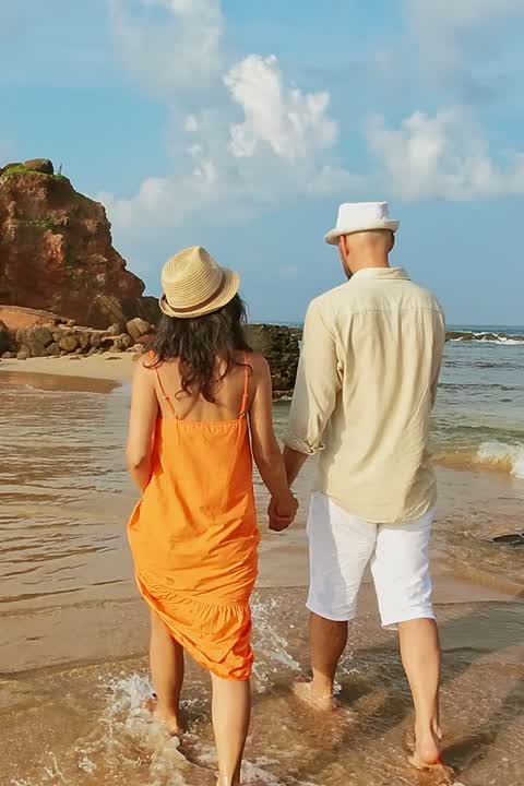 A couple walking by Parrot Rock, Mirissa