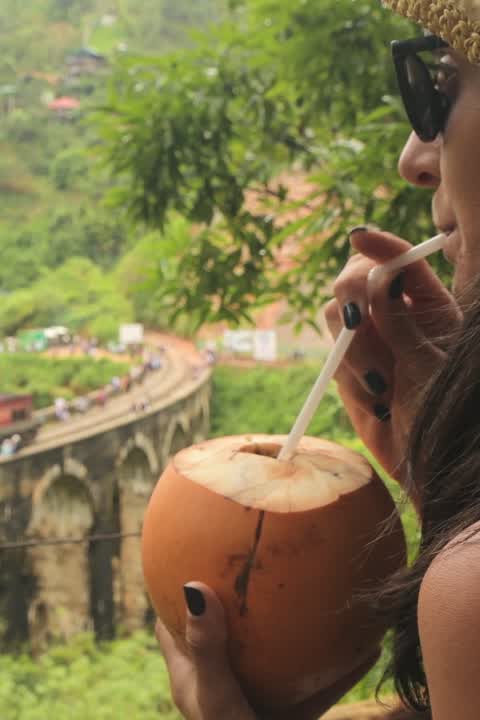 Drinking a king coconut at the Nine Arch Bridge
